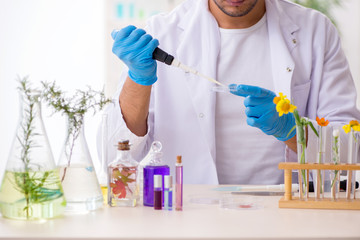 Young male chemist in perfume synthesis concept