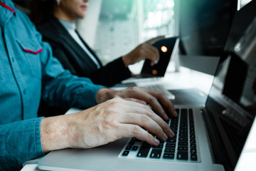 Developing programming and coding technologies working in a software engineers developing applications together in office.