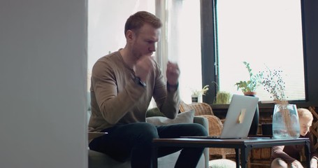 Wall Mural - Mid 30s Caucasian male working from home, checking documents. Kids playing in the background. Stay home, quarantine remote work. Shot on RED Dragon