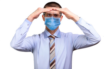 Wall Mural - Businessman in shirt, medical mask and glasses looks into camera far away, holds hands house