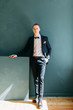 © pavelvozmischev - Portraits of a man in a jacket on a neutral background. Stylish portraits of the happy groom.