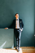 © pavelvozmischev - Portraits of a man in a jacket on a neutral background. Stylish portraits of the happy groom.