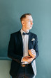 © pavelvozmischev - Portraits of a man in a jacket on a neutral background. Stylish portraits of the happy groom.