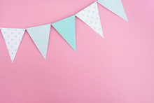 Paper Party Flags On Pastel Pink Background. Birthday Party, Decorative Accessories, Celebration. Minimal Composition. Top View, Flat Lay, Copy Space