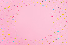 Sweet Colorful Confetti On Pastel Pink Background. Minimal Trendy Composition. Birthday Party, Celebration, Mockup For Design. Top View, Frame, Flat Lay, Copy Space