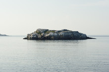 Uninhabited Small Isle With Smooth Granite Rocks And Green Moss, Lichen In Blue Arctic Ocean In Clear Day, Horizon, Arctic Landscape.