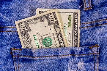 American twenty dollar banknotes in a pocket of blue jeans