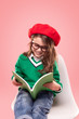 © kegfire - Cheerful stylish girl reading textbook