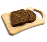 Fototapeta Miasta - Pieces of brown bread on the board