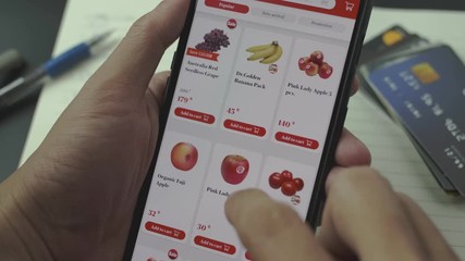 close up hand select fruit shopping food on app of smartphone at home