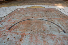 Old Basketball Court And Leaves On The Floor