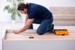 © Elnur - Young male contractor installing furniture at home
