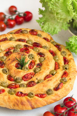 Wall Mural - Homemade italian flat bread Focaccia contorta. With olives, olive oil, rosemary, tomatoes. Traditional recipe. Vegan. White concrete texture background.