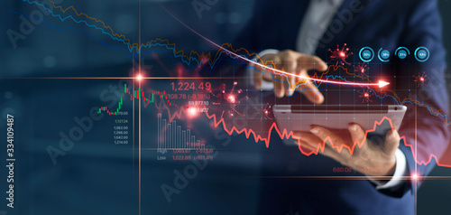 Economic crisis, Businessman using tablet analyzing sales data and economic graph chart that is falling due to the corona virus crisis, Covid-19, stock market crash caused Tableau sur Toile