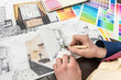 © RomanR - young designer is working on a new project, choosing the perfect color for a modern apartment renovation.