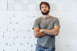 © fotofabrika - Close up Portrait of a young bearded man standing against grunge weathered wall