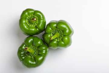 Wall Mural - fresh green bell pepper (capsicum) on a white background