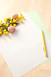 Easter mockup with blank paper, yellow pen, decoration, flowers. Copy space for Happy Easter wishes, letter text. Top view. Catholic, orthodox celebration.