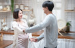 © mkitina4 - Joyful pregnant asian couple have fun, dancing next to window in kitchen at home, with copy space.health care and love of pregnancy mother’s day concept.