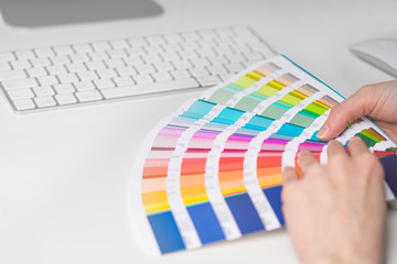 Graphic designer works on the choice of palette colors for creative business