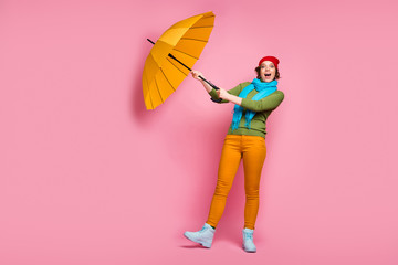 Poster - Full body photo excited girl travel trip her shine umbrella fly wind air she try catch scream wow omg wear blue red headwear pullover winter pants isolated pink color background