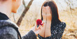 © Strelciuc - Caucasian excited woman covering her face after being asked for marriage by her lover