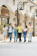 © DragonImages - Joyful Asian young people enjoying walking in the street on sunny day