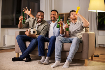 Wall Mural - friendship, sports and entertainment concept - happy male friends with soccer ball, beer and vuvuzela supporting football team at home