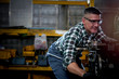 © Stella - Industrial engineer worker wearing helmet and safe glasses  operating with machinery at manufacturing plant factory, working with machine in industry concept