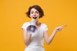 © ViDi Studio - Excited young brunette woman girl in white t-shirt posing isolated on yellow orange background in studio. People lifestyle concept. Mock up copy space. Scream in megaphone pointing index finger aside.