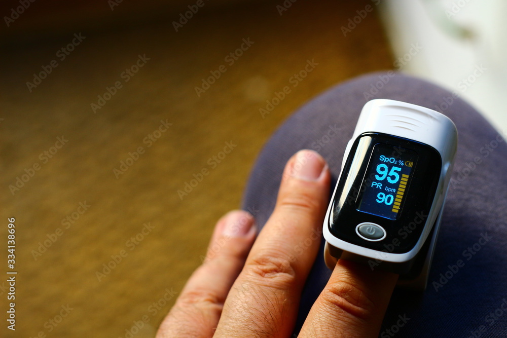 Pulse oximeter measuring oxygen saturation in blood and heart rate - obrazy, fototapety, plakaty 