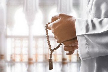 Sticker - Religious muslim man praying with rosary beads