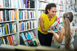 © JackF - woman giving books to girl in store.