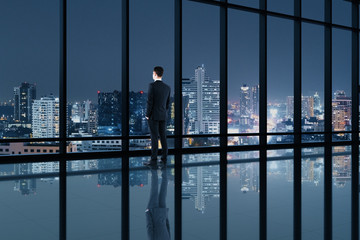 Wall Mural - Businessman standing in contemporary office interior