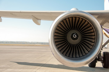 Maintenance of engine in an airplane. Turbine of airplane. Jet airplane wing and engine front view. Turboprop aircraft engine closeup shot. Turbine blades of aircraft jet engine.