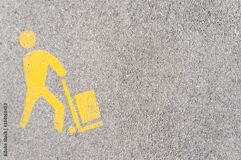 Road markings (yellow on black asphalt) of a parking spot for loading ...