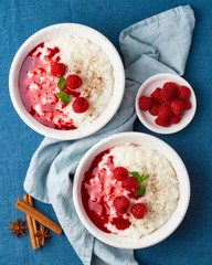 Wall Mural - Rice pudding. French milk rice dessert with raspberries, blueberries. Top view, vertical