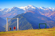 Georgia, Svaneti area. View point near Mestia with a view of the Caucasus mountains. People on swings admire the view of the mountain peaks.