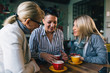 © cherryandbees - women in cafe drinking coffee and talking