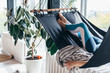 © undrey - Woman is lying at home in a hammock and resting