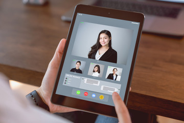 Wall Mural - Businesswoman making video call meeting to team online.