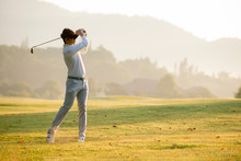 Asian Man Golfer Playing Golf With Friend  At Golf Course , Golfer Hitting Golf Ball