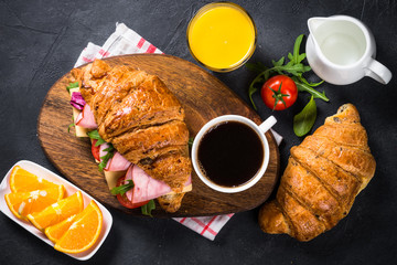 Canvas Print - Croissant sandwich on black table.