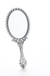 Hand mirror in front of a white background