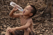 Asian boys are currently lacking clean water for consumption. concept climate change