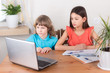© lovelymama - Children boy and girl on distance education, homeschooling and doing homework. E-learning at home, web lesson concept