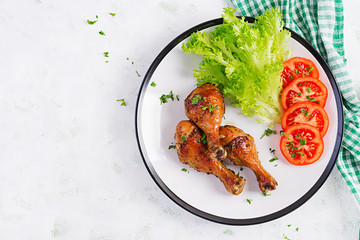 Wall Mural - Grilled chicken legs with spices and fresh vegetables. Baked drumsticks. Top view, flat lay