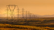 © RooM The Agency - Electrical power lines through a rural landscape at sunset, USA
