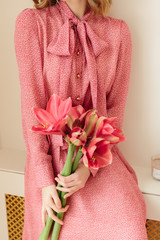 Close up portrait of an attractive young woman in summer dress holding flowers bouquet. Fashion spring summer photo 