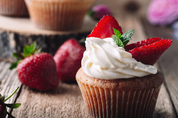 Wall Mural - Homemade cupcakes with strawberries and cream